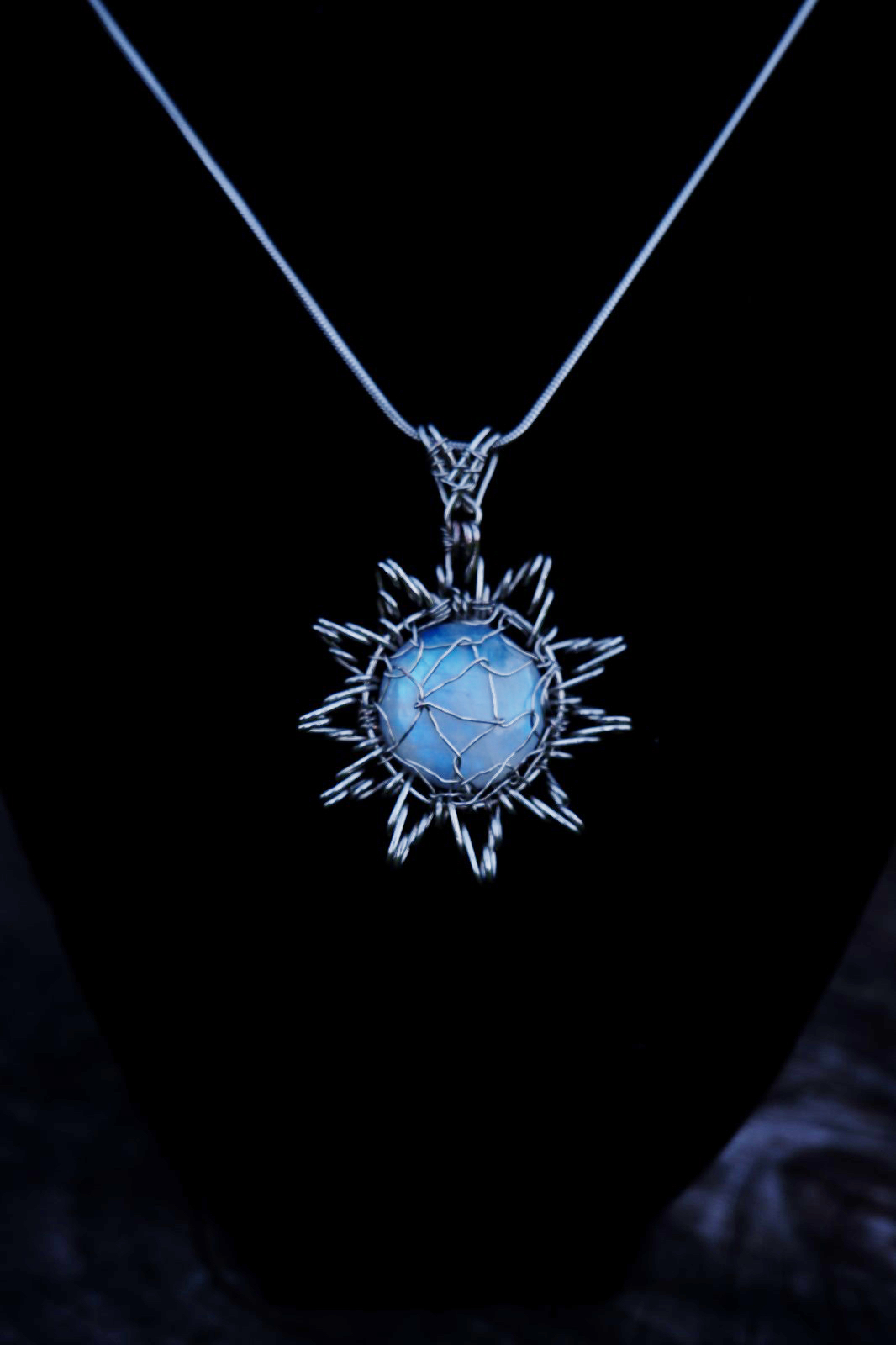 Star Moon Stone Round Round Moonstone with silver colour copper wire. Wire surrounding the stone like a star.